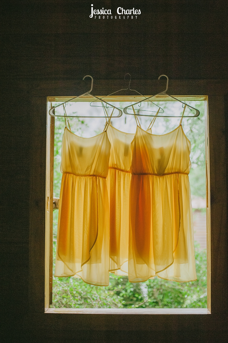 bridesmaids dresses hanging in a window